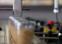 A food packaging line featuring the Ax130i CIJ printer